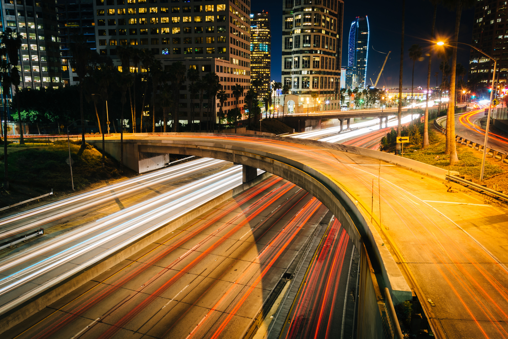 Traffic on the 110 Freeway and buildings in Los Angeles at night, seen from the 5th Street Bridge, in downtown Los Angeles, California.